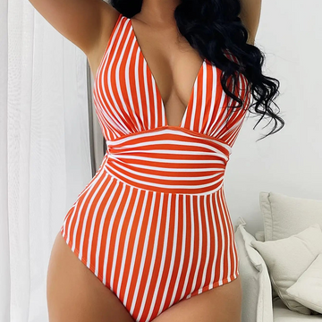 Red and white striped swimsuit worn by a person indoors.